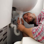 Plumber Repairing A Sink